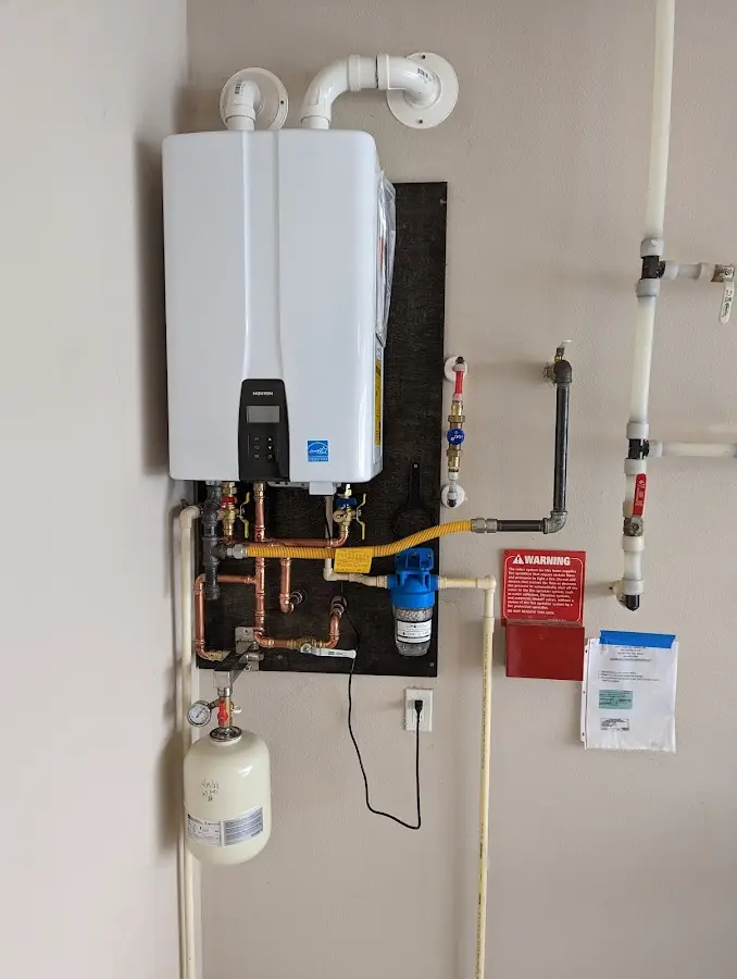Professional plumber installing copper piping in a Stacy home